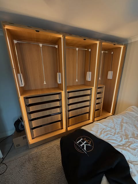 Three fitted wardrobes with LED lighting, drawers and pull-down hanging rails
